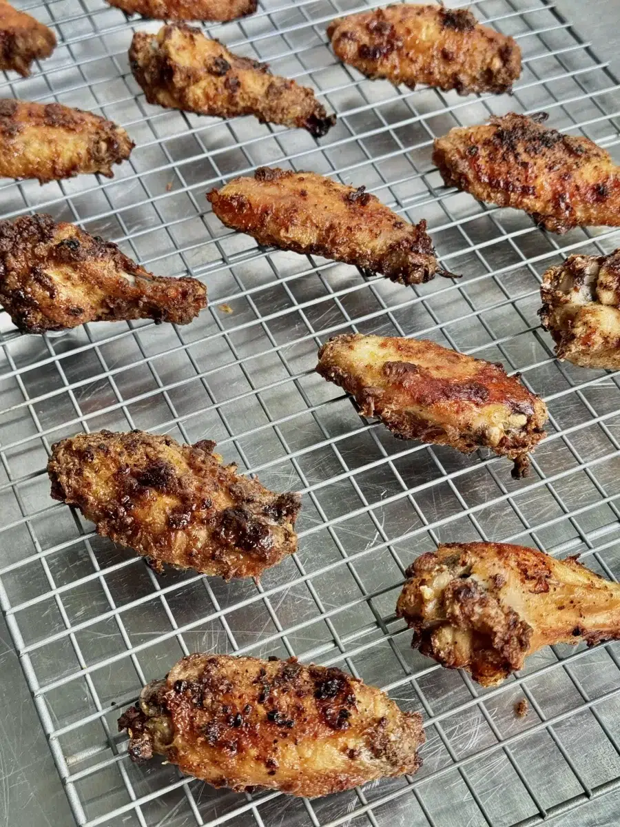 Crispy Chicken Wings Cooling on a wire rack